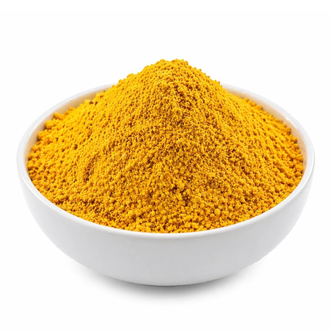 Yellow powder in a white bowl on a white background